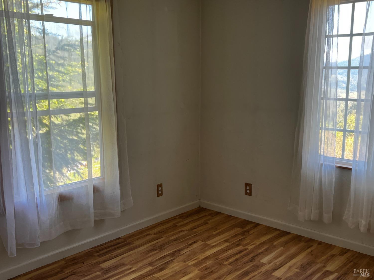 3761 East Blue Rock Road Garberville, CA 95542 - Photo 10 of 38 a view of an empty room with wooden floor and a window