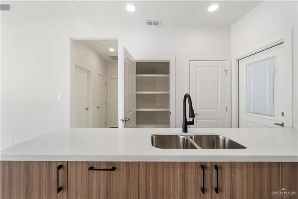 a kitchen with stainless steel appliances a sink and cabinets