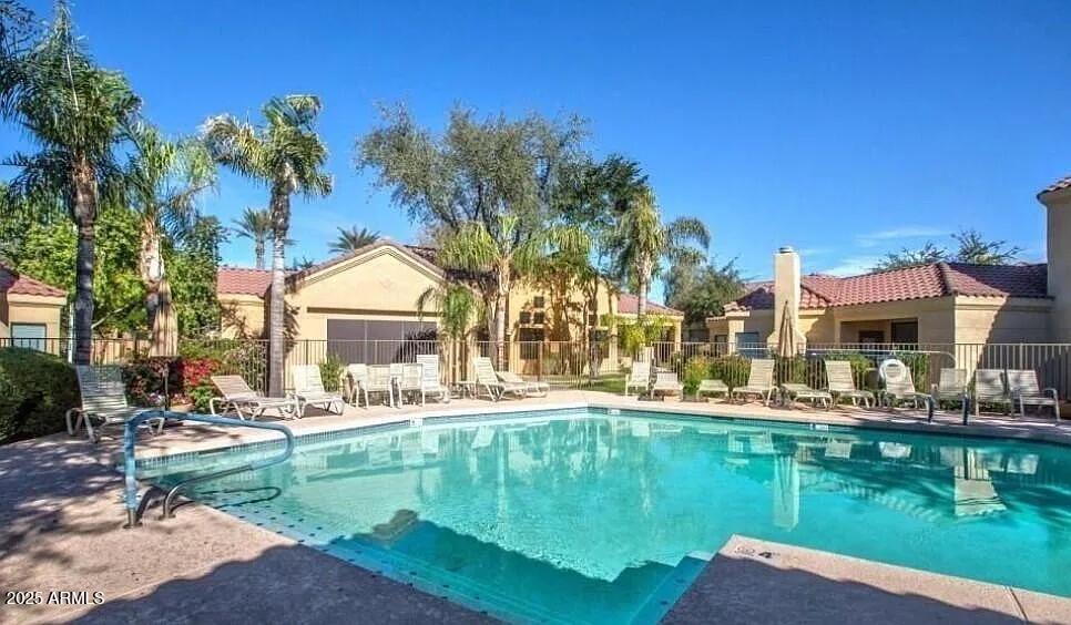 7575 East Indian Bend Road, Unit 2002 Scottsdale, AZ 85250 - Photo 10 of 24 a swimming pool view with a seating space and a lake view