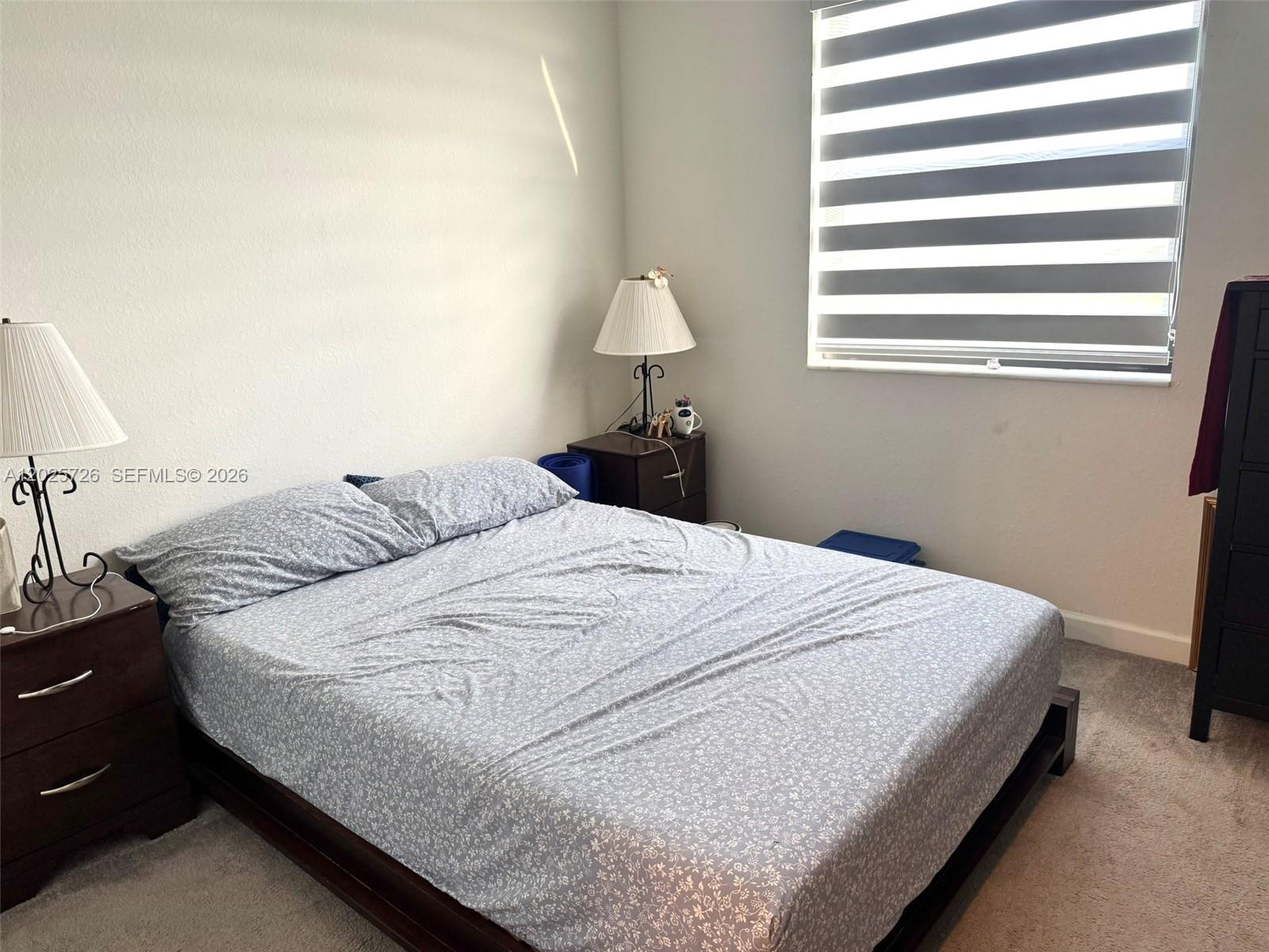 10020 Southwest 228th Terrace Miami, FL 33190 - Photo 10 of 22 a bedroom with a bed and window