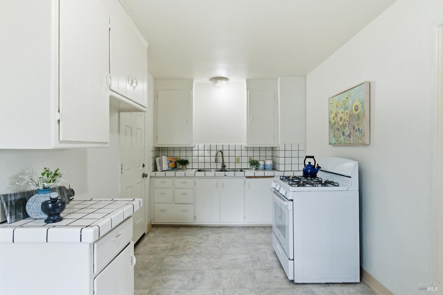 691 Annette Avenue Vallejo, CA 94591 - Photo 14 of 41 a kitchen with sink cabinets and stove