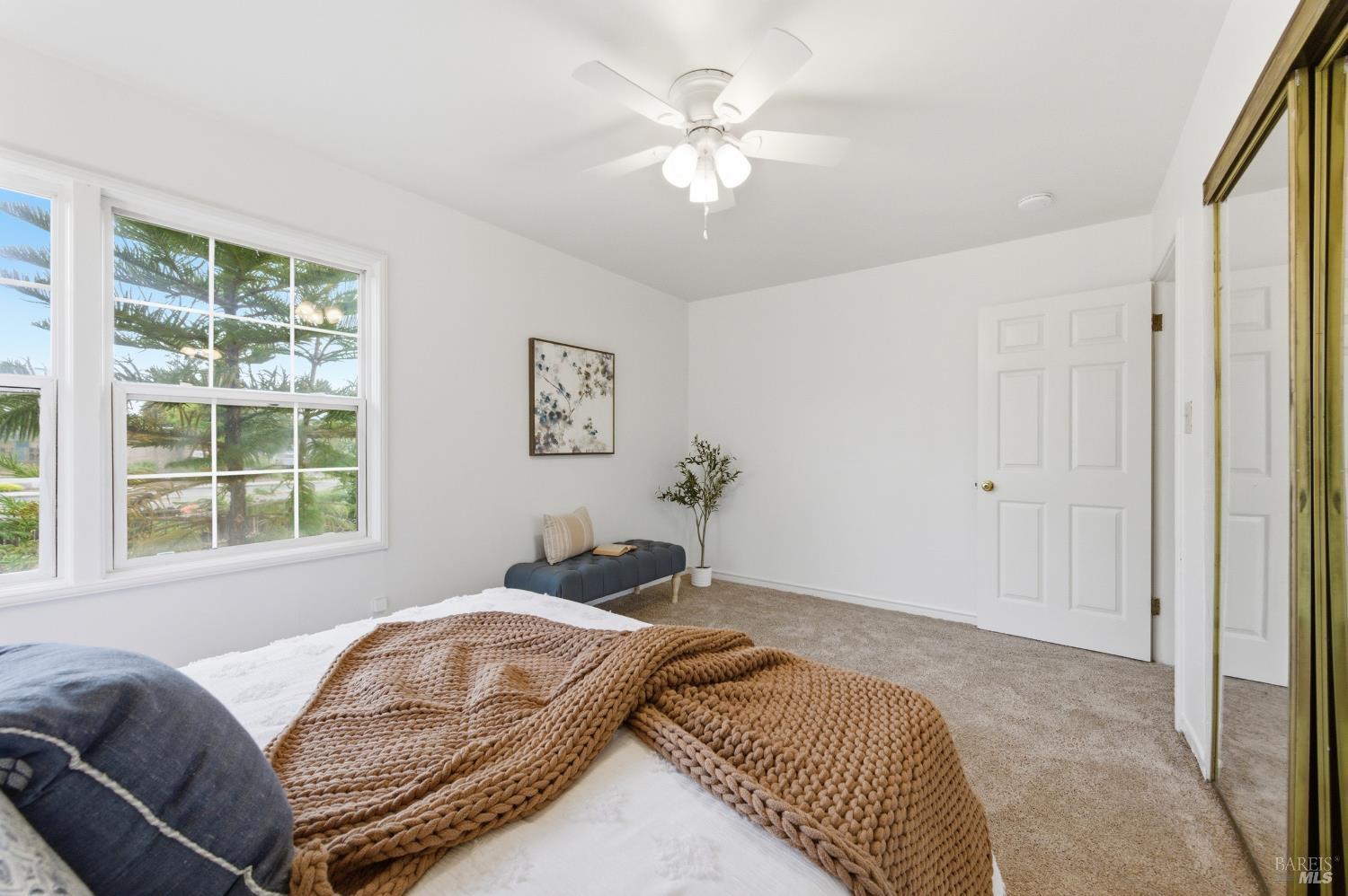 691 Annette Avenue Vallejo, CA 94591 - Photo 18 of 41 a bedroom with a large bed chandelier and a window