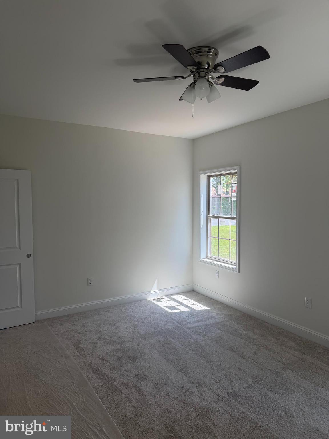 54 3rd Avenue Chambersburg, PA 17202 - Photo 7 of 8 an empty room with a window and a ceiling fan