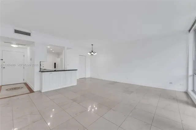 a view of a kitchen with white cabinets