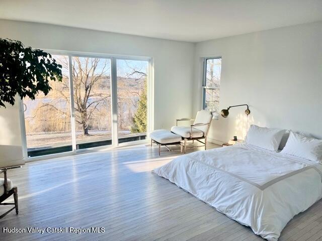 188 Mt Merino Road Hudson, NY 12534 - Photo 7 of 23 a bedroom with a bed and wooden floor