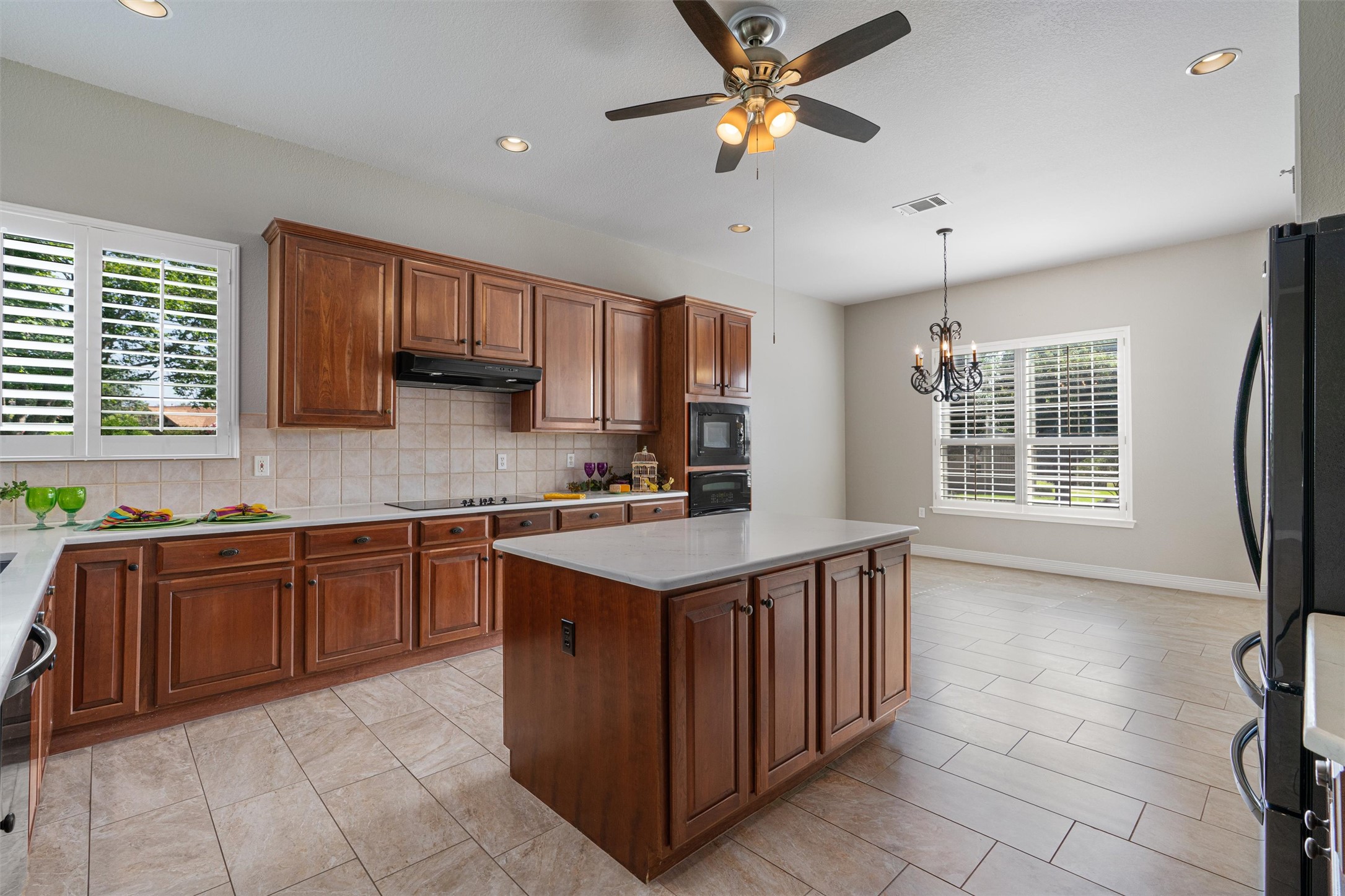 282 Trail Of The Flowers Georgetown, TX 78633 - Photo 12 of 38 a kitchen with stainless steel appliances granite countertop a stove a sink a refrigerator and island