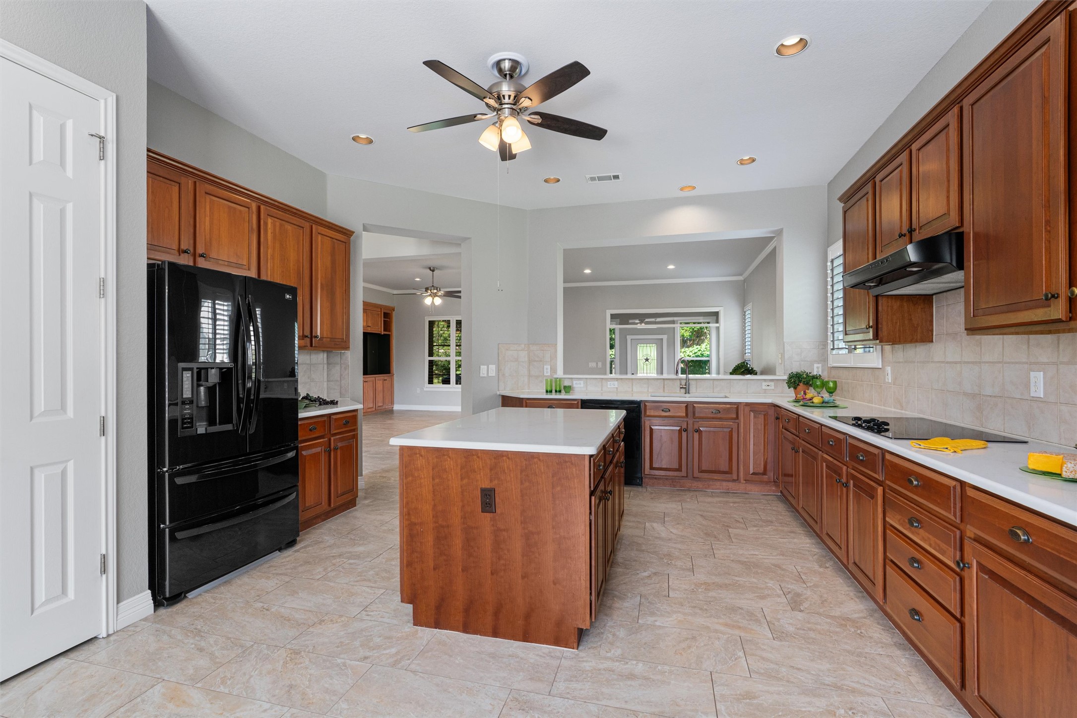 282 Trail Of The Flowers Georgetown, TX 78633 - Photo 14 of 38 a large kitchen with stainless steel appliances kitchen island granite countertop a refrigerator and a sink