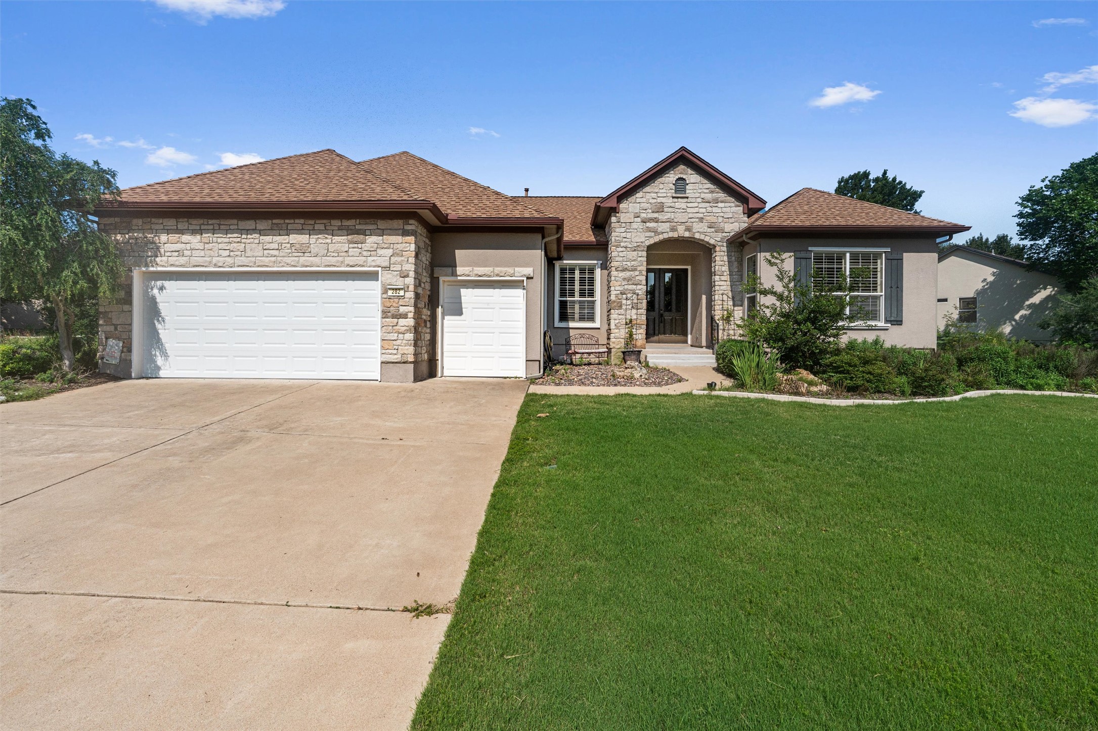 282 Trail Of The Flowers Georgetown, TX 78633 - Photo 2 of 38 a front view of a house with a yard and garage