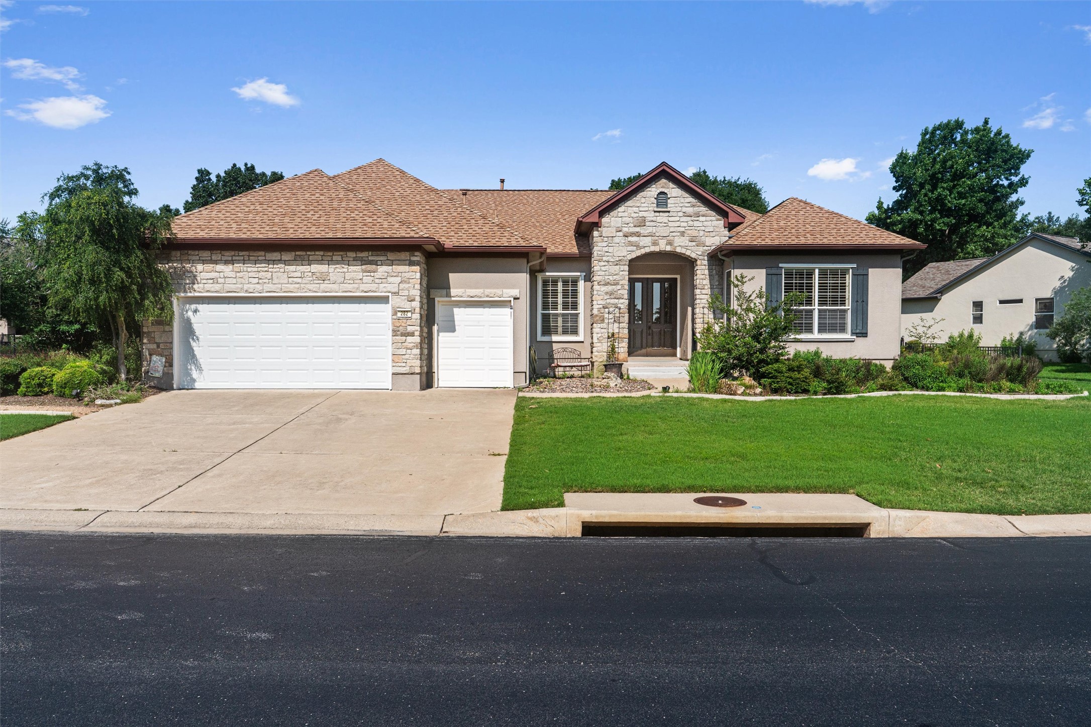 282 Trail Of The Flowers Georgetown, TX 78633 - Photo 3 of 38 a front view of a house with a yard and garage