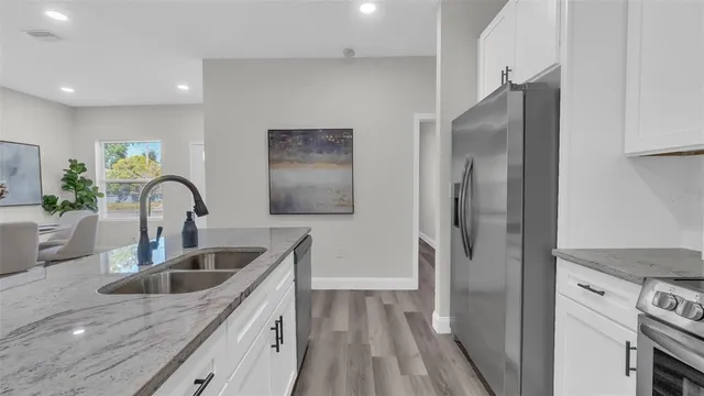 a kitchen with a sink and a refrigerator