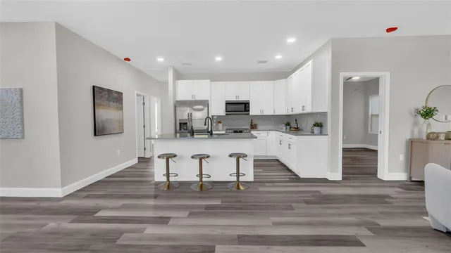 a view of living room with granite countertop furniture and wooden floor