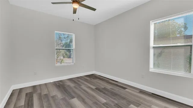 a view of a room with wooden floor and a bathroom