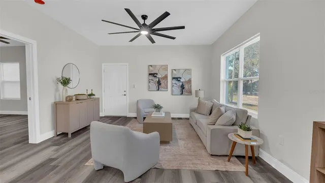 a living room with furniture and a book shelf