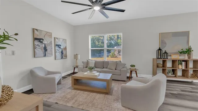 a living room with furniture and a bookshelf