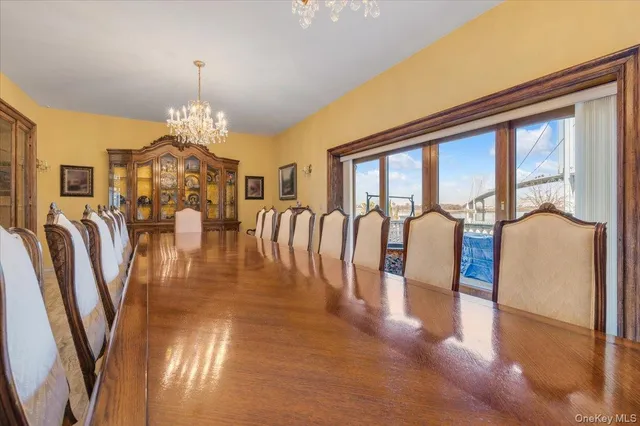 a view of a livingroom with furniture a chandelier and wooden floor