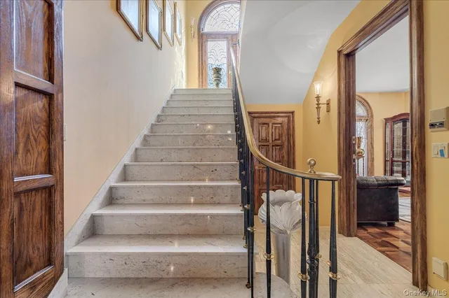 a view of entryway and hall with wooden floor