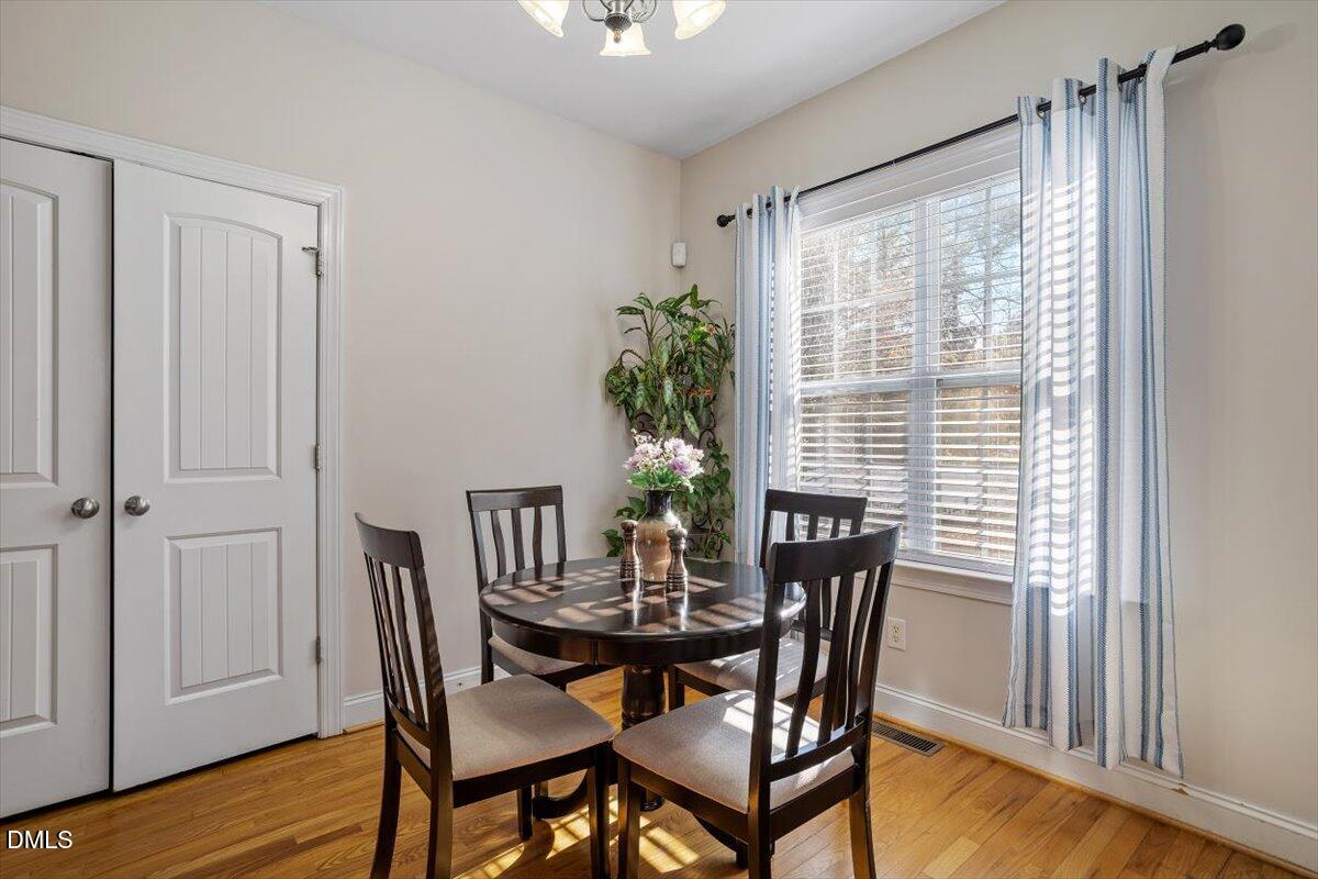 541 Spruce Meadows Lane Willow Spring, NC 27592 - Photo 12 of 40 a view of a dining room with furniture window and wooden floor