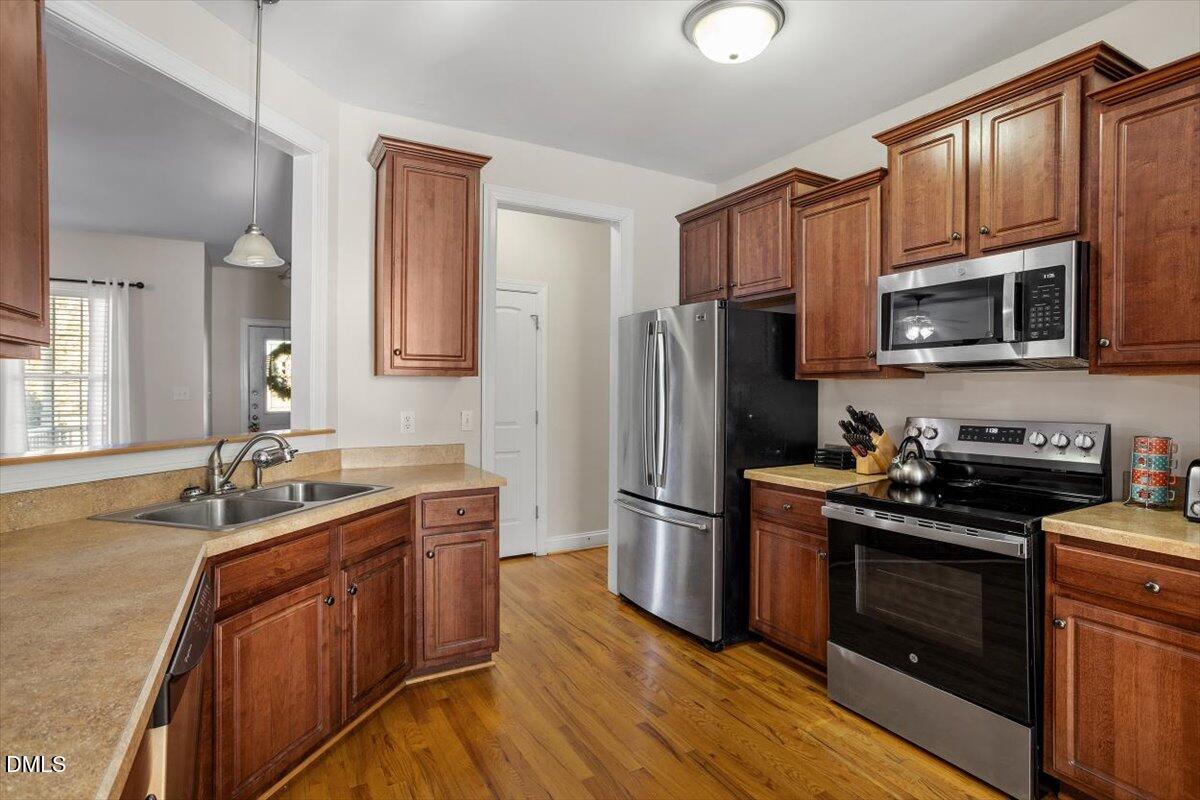 541 Spruce Meadows Lane Willow Spring, NC 27592 - Photo 16 of 40 a kitchen with a sink stove and refrigerator