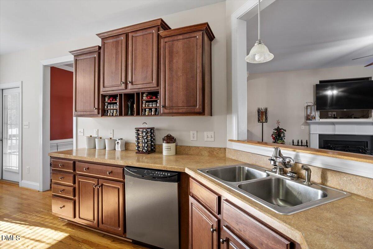 541 Spruce Meadows Lane Willow Spring, NC 27592 - Photo 18 of 40 a kitchen with kitchen island granite countertop a sink dishwasher stove and cabinets
