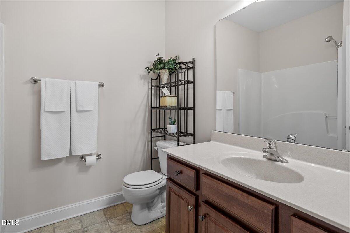 541 Spruce Meadows Lane Willow Spring, NC 27592 - Photo 22 of 40 a bathroom with a sink a toilet and shower