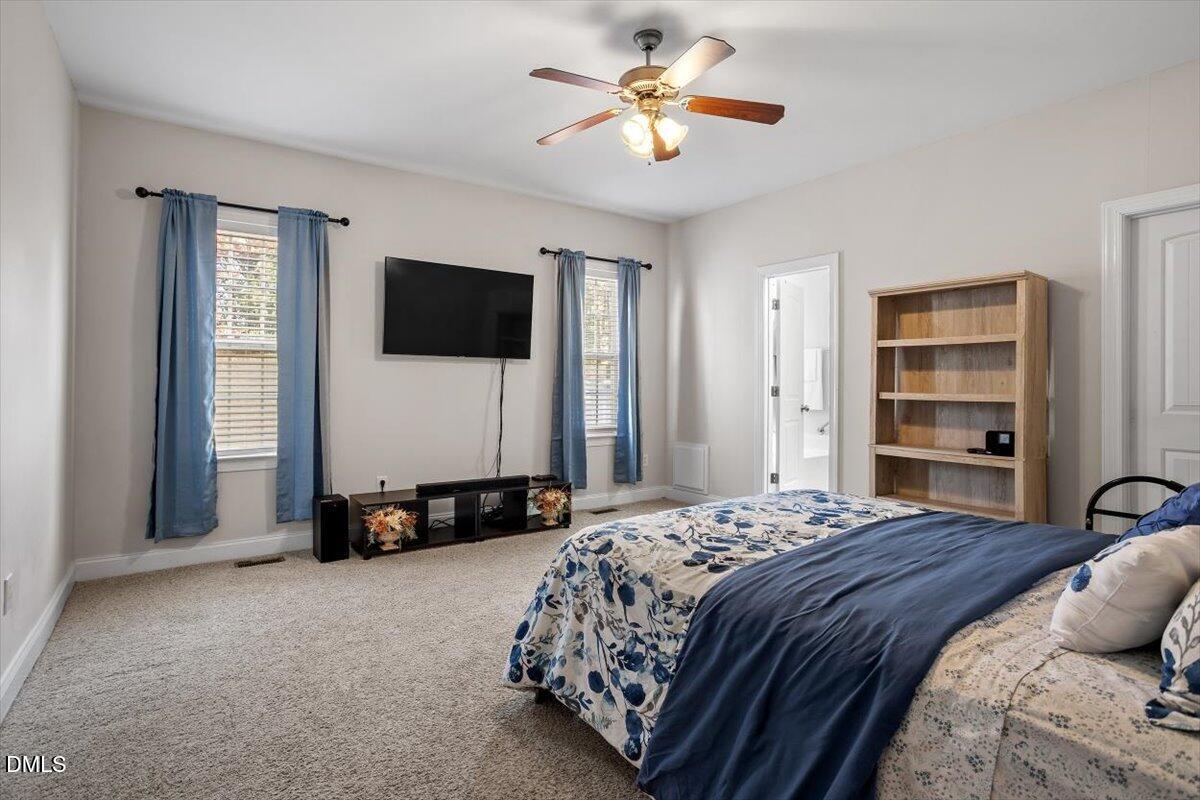 541 Spruce Meadows Lane Willow Spring, NC 27592 - Photo 25 of 40 a bedroom with a bed and a flat screen tv
