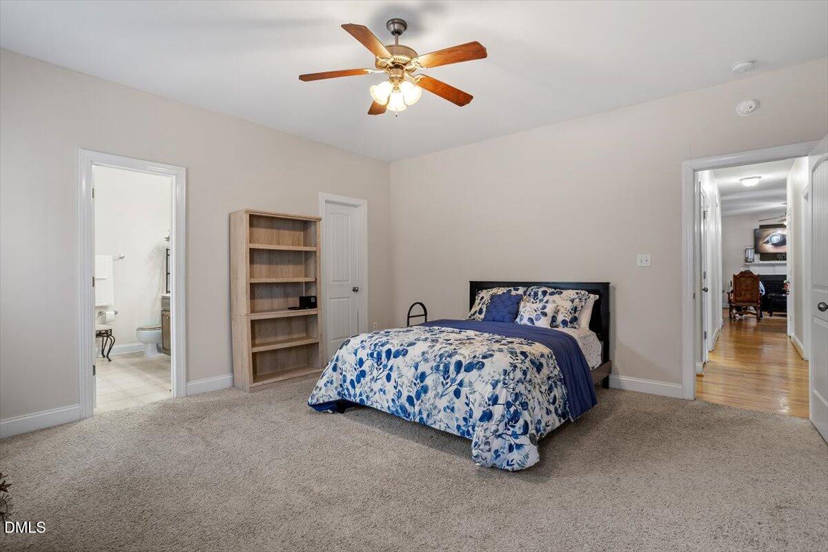 541 Spruce Meadows Lane Willow Spring, NC 27592 - Photo 26 of 40 a bedroom with bed and a chandelier