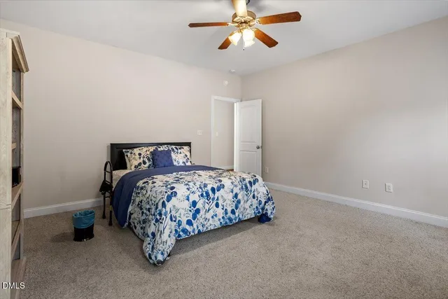 a bedroom with bed and a chandelier