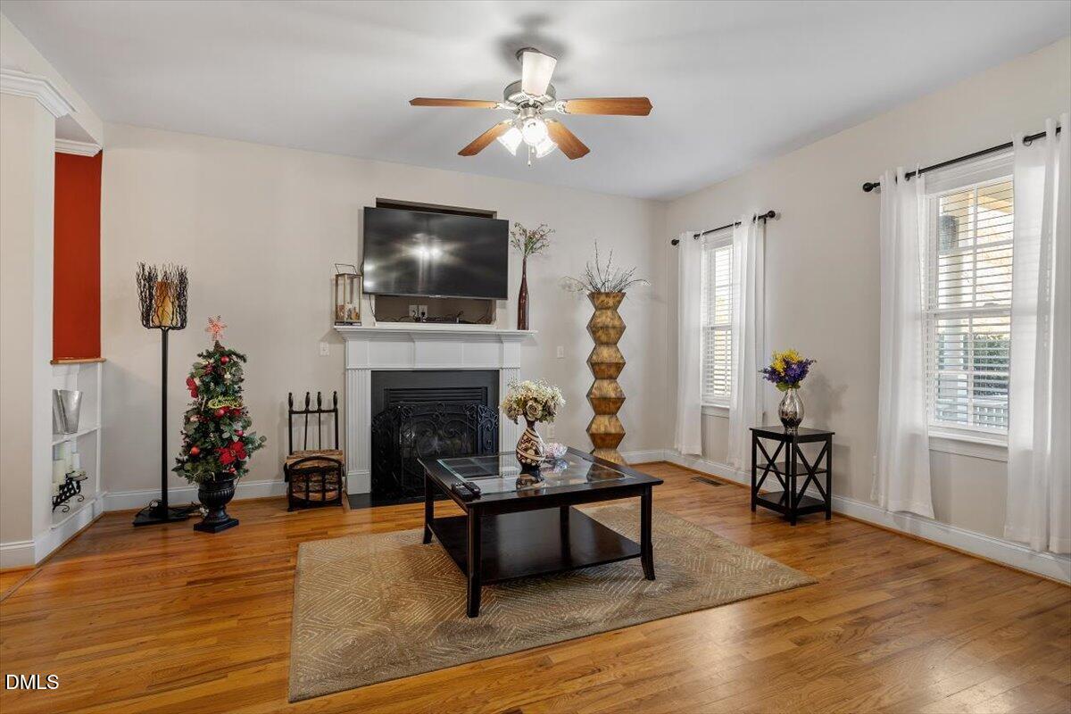 541 Spruce Meadows Lane Willow Spring, NC 27592 - Photo 6 of 40 a living room with furniture a fireplace and a flat screen tv