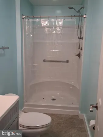 a bathroom with a shower and a toilet