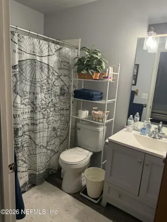 a bathroom with a sink toilet and shower