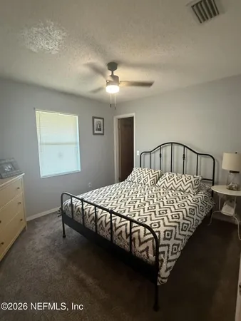 a bed sitting in a bedroom next to a window