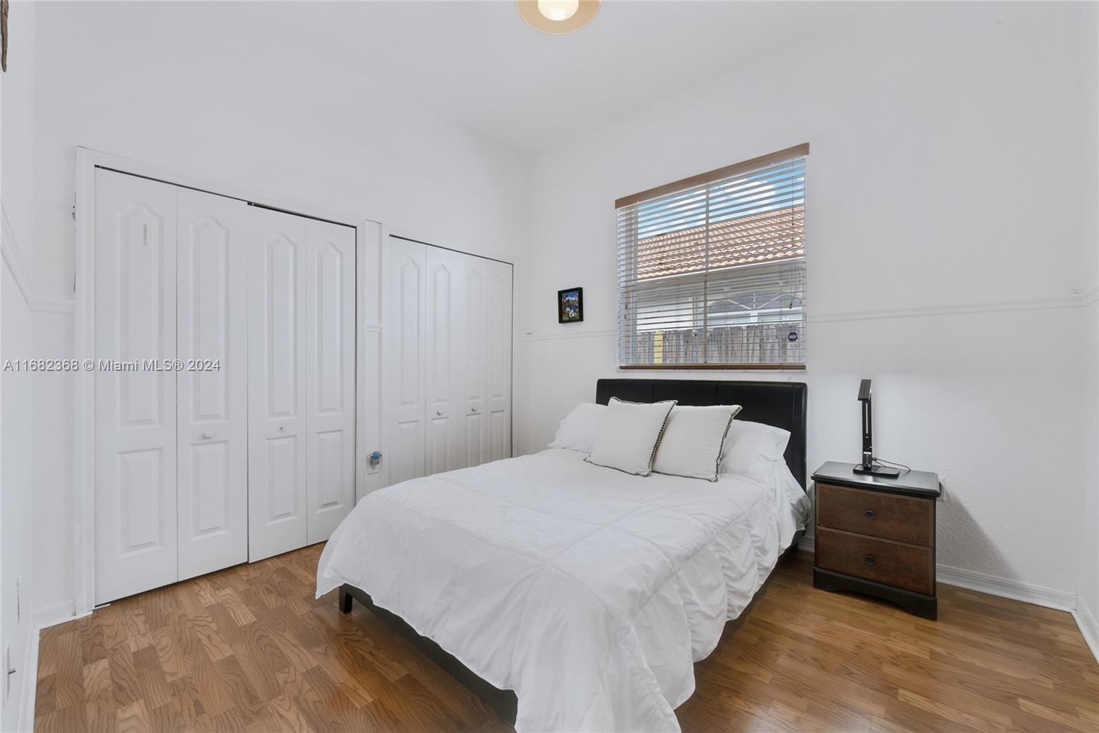 6850 Southwest 159th Place Miami, FL 33193 - Photo 13 of 18 a bedroom with a bed and a window