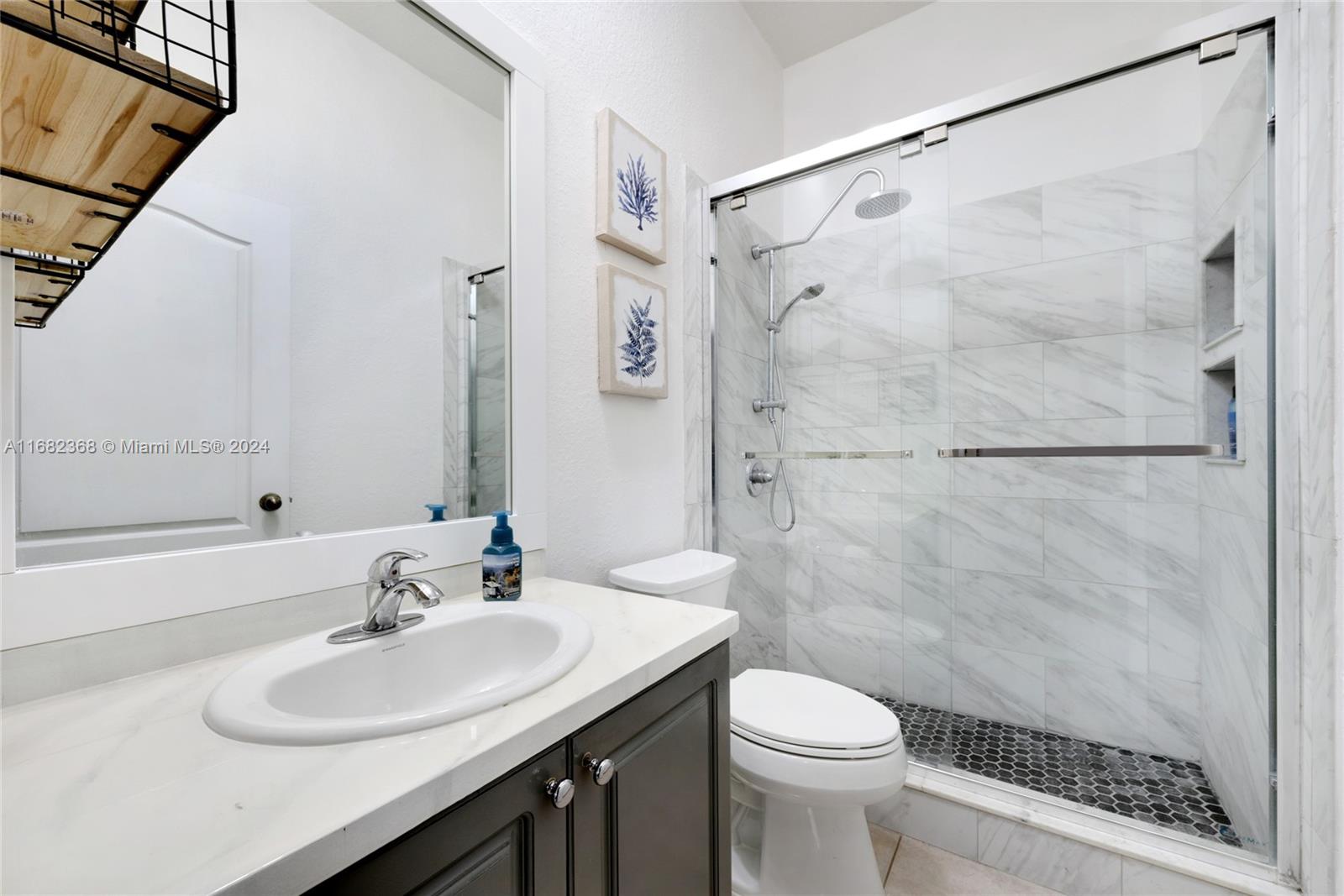 6850 Southwest 159th Place Miami, FL 33193 - Photo 14 of 18 a bathroom with a sink toilet and shower