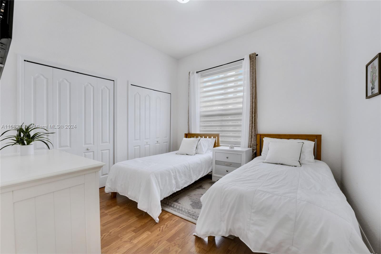 6850 Southwest 159th Place Miami, FL 33193 - Photo 15 of 18 a bedroom with two beds and a potted plant