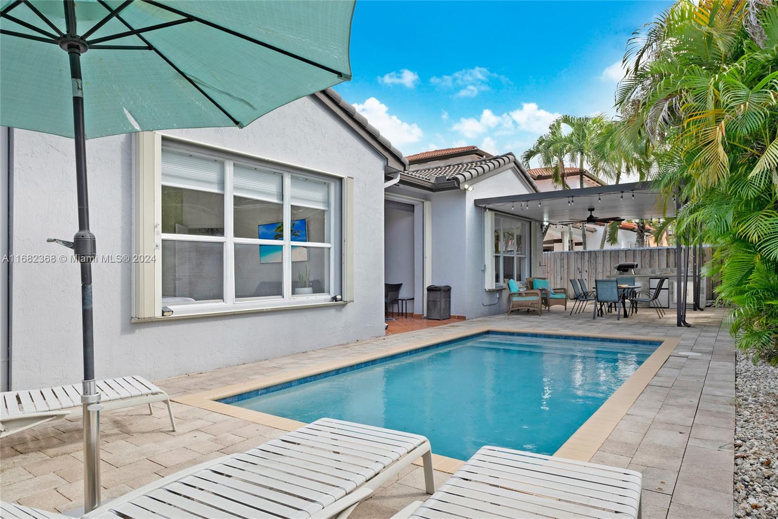 6850 Southwest 159th Place Miami, FL 33193 - Photo 17 of 18 a view of a house with a swimming pool
