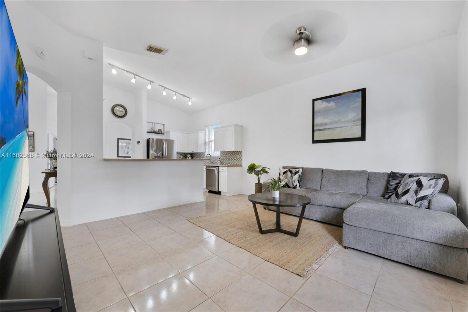 6850 Southwest 159th Place Miami, FL 33193 - Photo 5 of 18 a living room with furniture and kitchen view