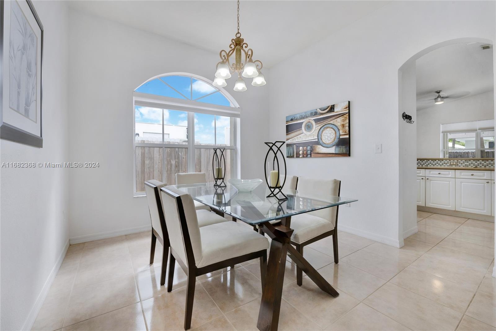 6850 Southwest 159th Place Miami, FL 33193 - Photo 6 of 18 a view of a dining room with furniture window and outside view