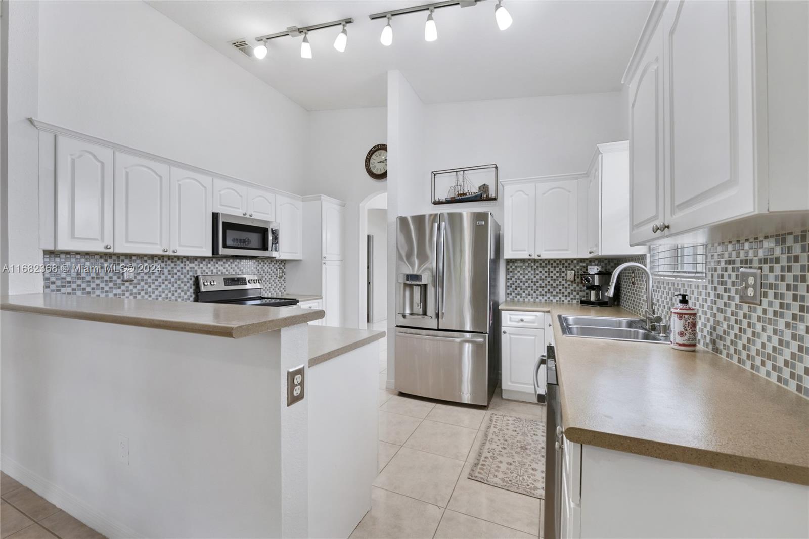 6850 Southwest 159th Place Miami, FL 33193 - Photo 8 of 18 a kitchen with stainless steel appliances a refrigerator stove microwave and sink