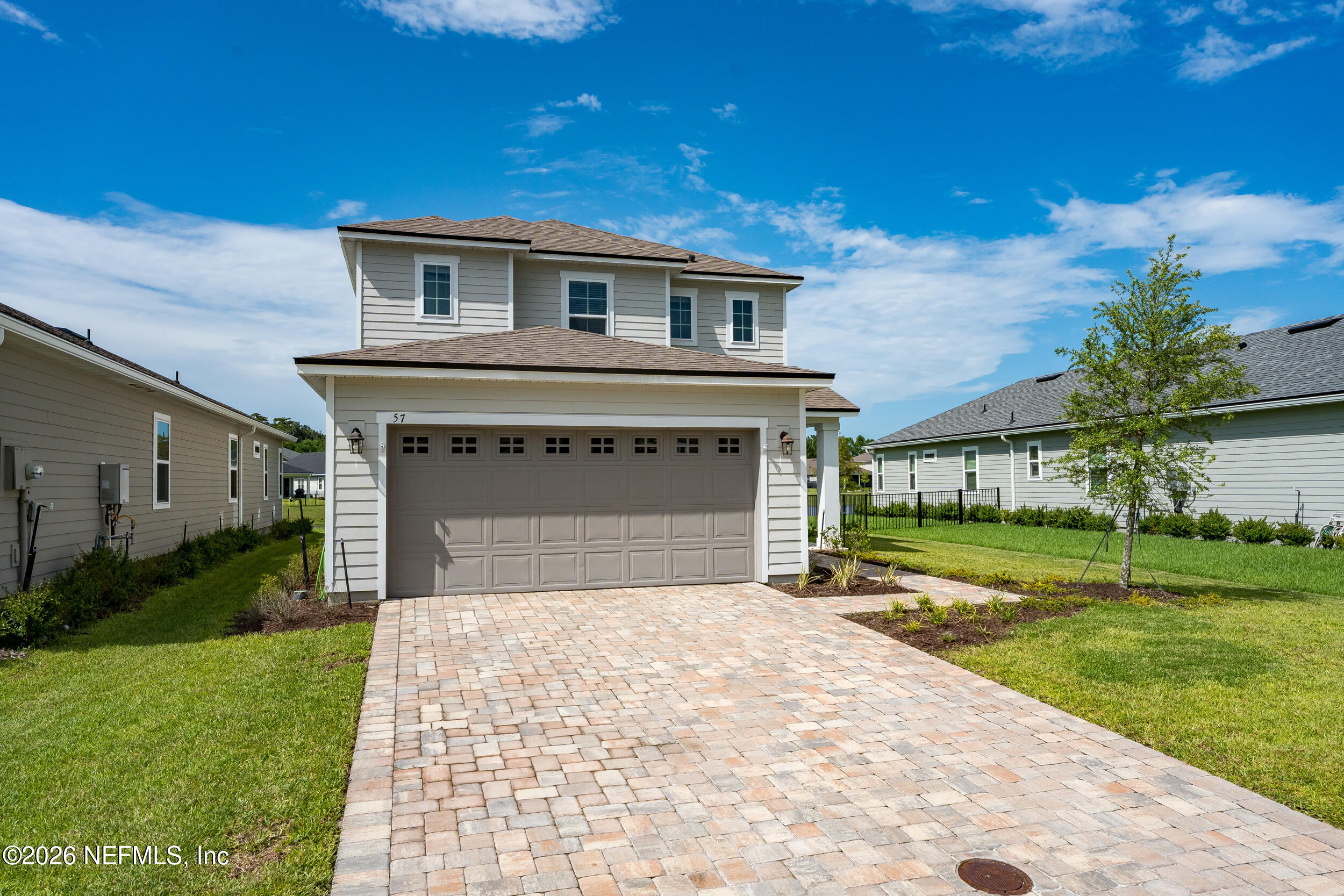 57 Cedar Elm Way St. Augustine, FL 32092 - Photo 3 of 65 a front view of a house with a yard and garage