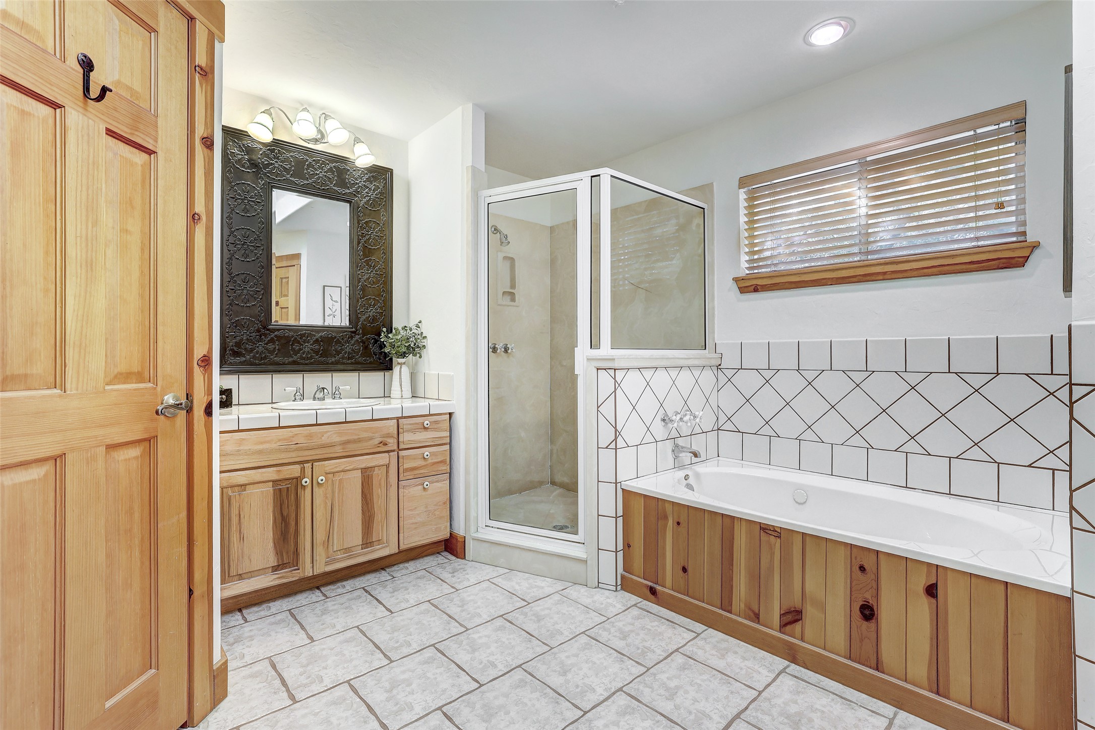 125 Kyle Lane Georgetown, TX 78633 - Photo 20 of 34 Bathroom featuring vanity, a stall shower, a garden tub, and light tile patterned floors