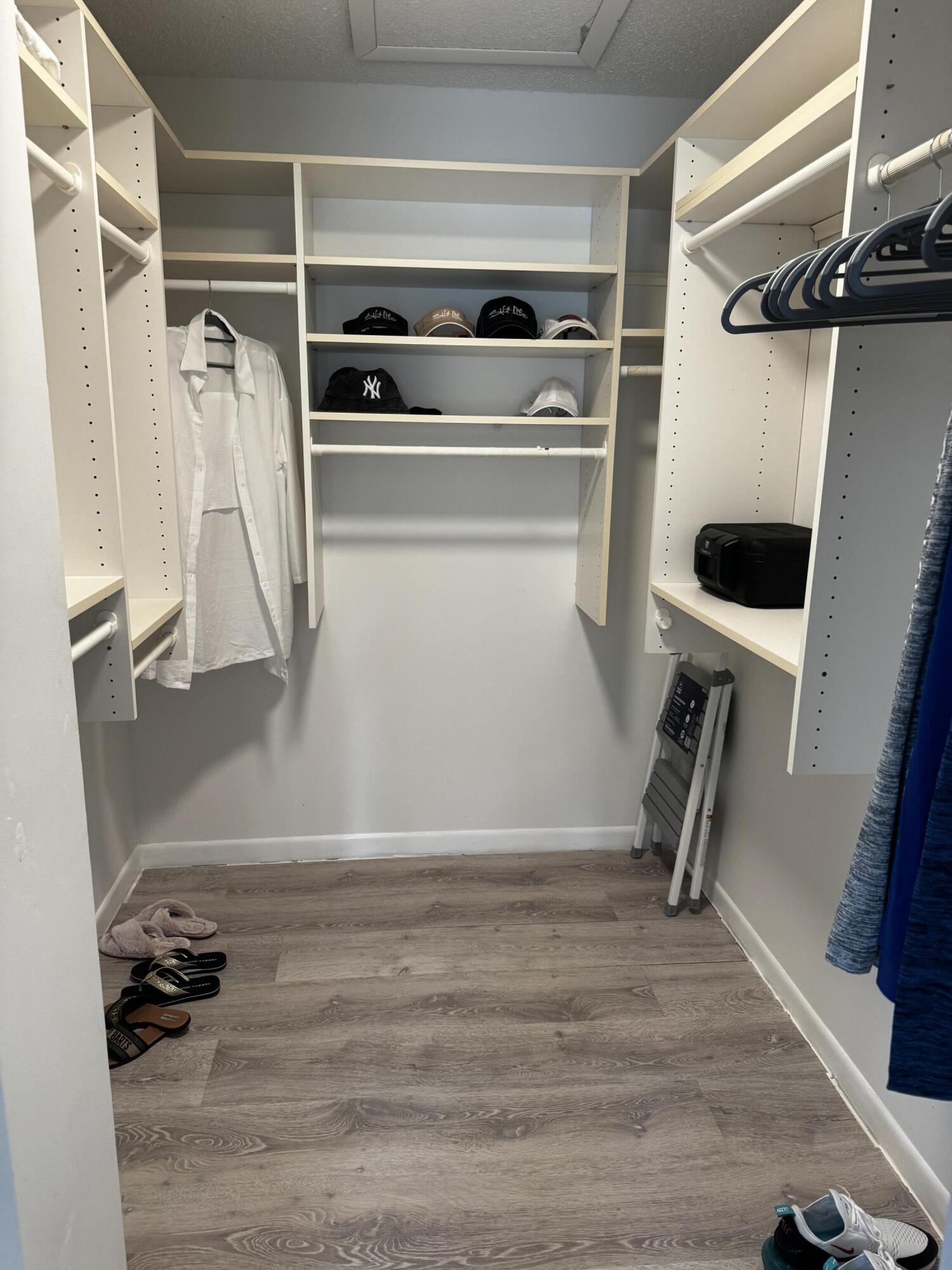 2502 Southeast Anchorage Cove, Unit G3 Port St. Lucie, FL 34952 - Photo 16 of 22 a view of walk in closet with clothes and shoes