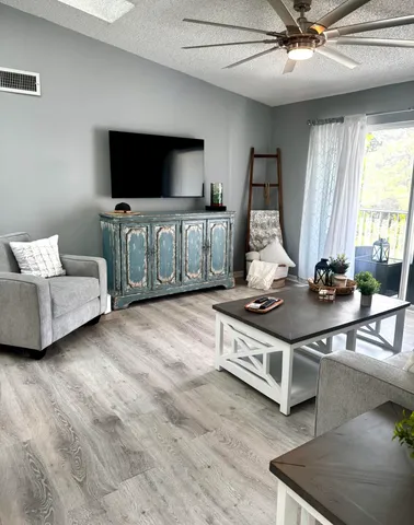 a living room with furniture and flat screen tv
