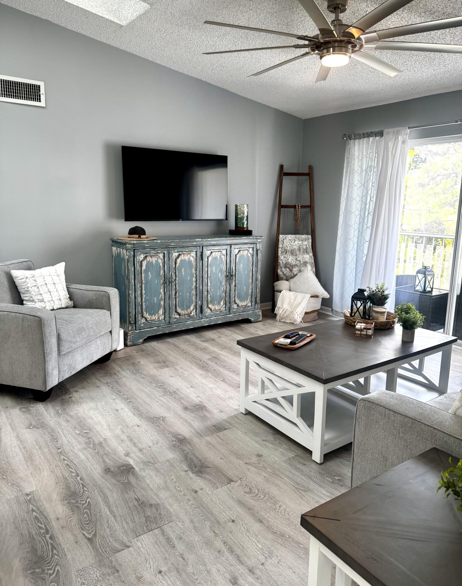 2502 Southeast Anchorage Cove, Unit G3 Port St. Lucie, FL 34952 - Photo 5 of 22 a living room with furniture and flat screen tv