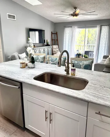 a kitchen with sink a window and dining table
