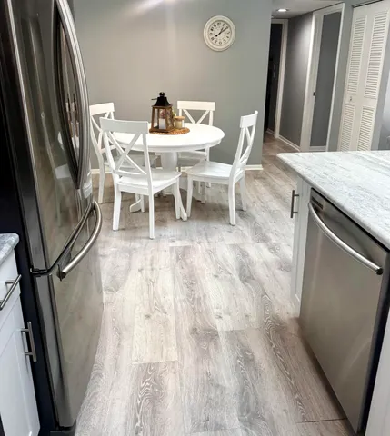 a view of a dining room with furniture and wooden floor