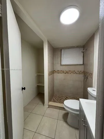 a bathroom with a toilet a sink and a shower