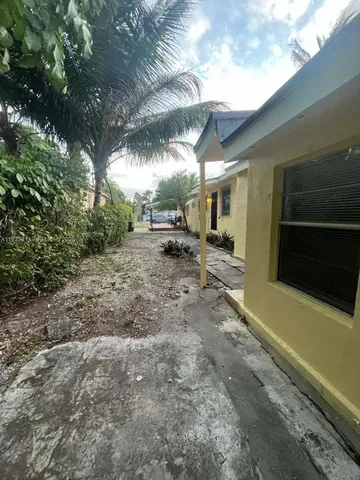 a view of a backyard with table and chairs
