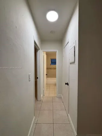 a view of hallway with an empty space and a window