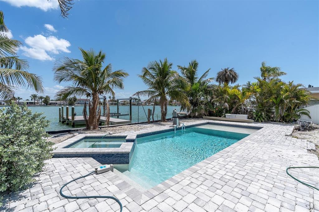 575 Crystal Drive Madeira Beach, FL 33708 - Photo 40 of 75 a swimming pool with outdoor seating