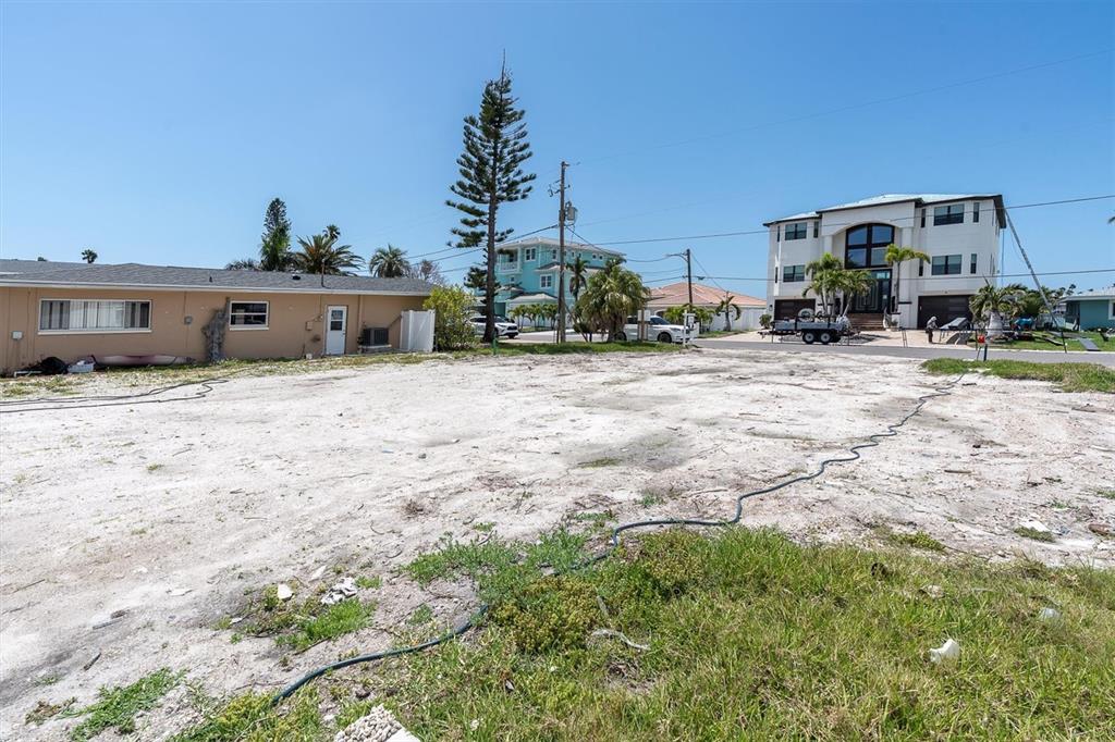 575 Crystal Drive Madeira Beach, FL 33708 - Photo 47 of 75 a backyard of a house with table and chairs